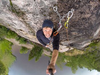 Portrait of man lying on rock formation