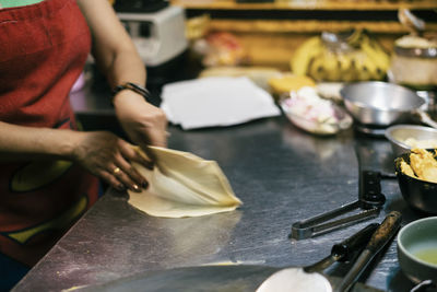 Midsection of man preparing food on table