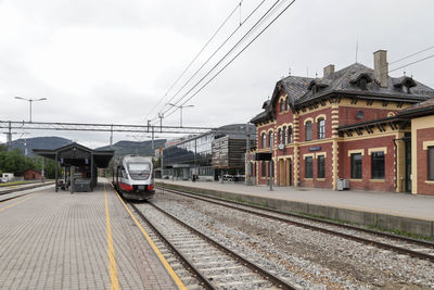 Train at railroad station against sky