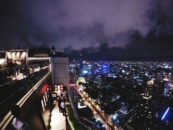 High angle view of illuminated cityscape against sky at night