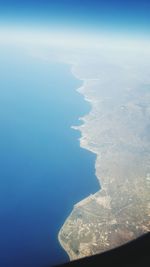 Aerial view of sea against blue sky