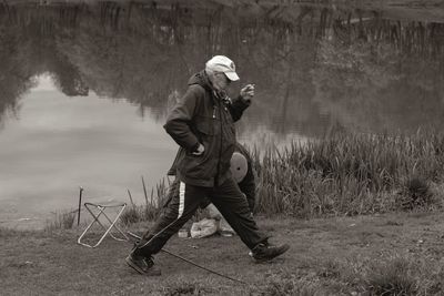 Full length of man walking by lake