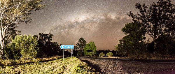 Road amidst trees against sky