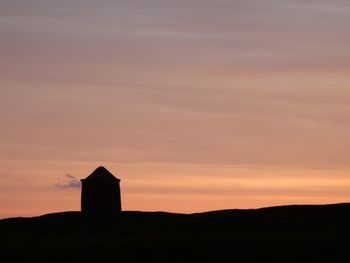 Silhouette temple against sky during sunset