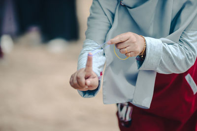 Midsection of doctor holding hands