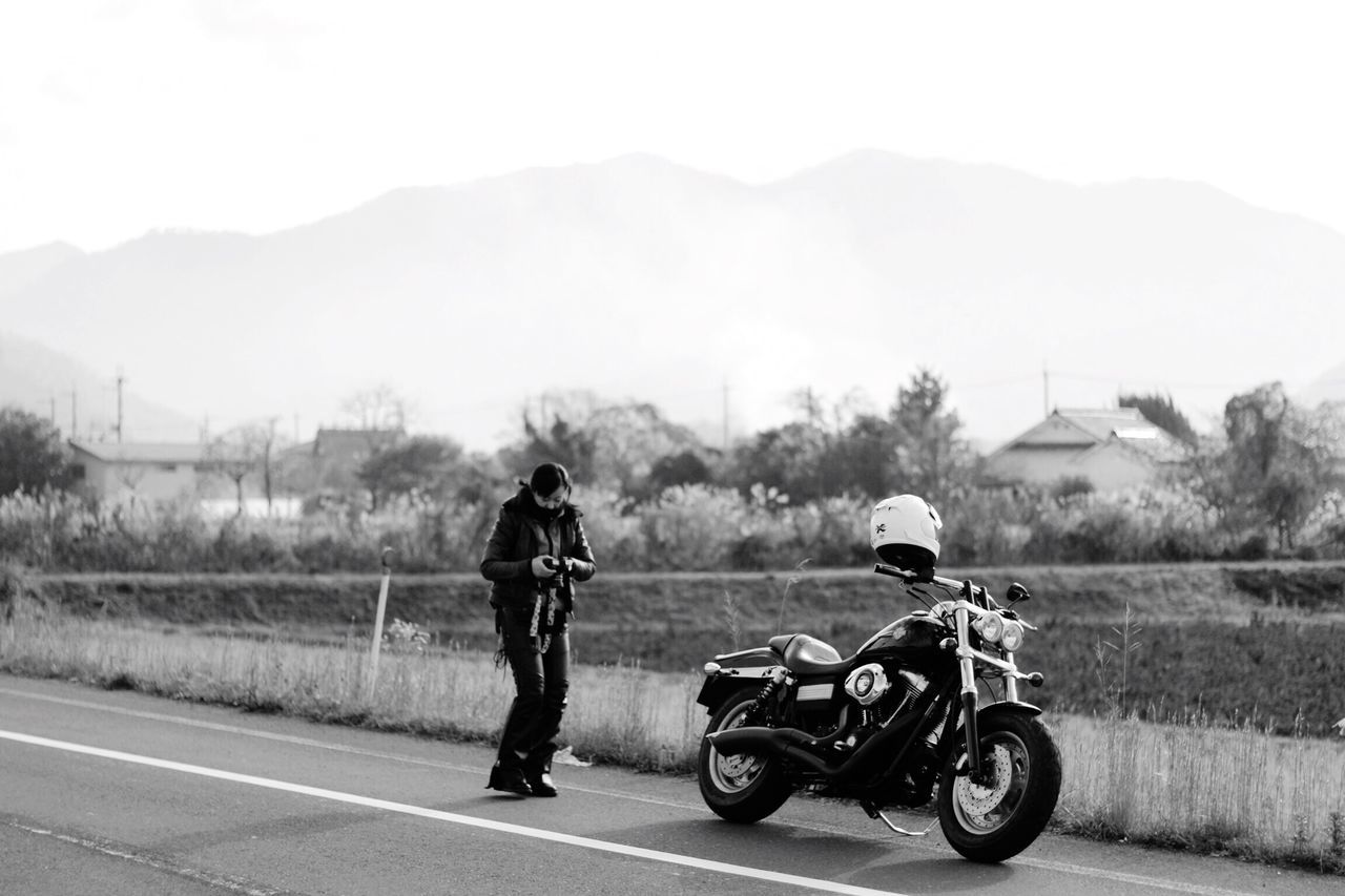 headwear, crash helmet, motorcycle, two people, real people, transportation, helmet, road, outdoors, day, men, mountain, sky, motorcycle racing, motorsport