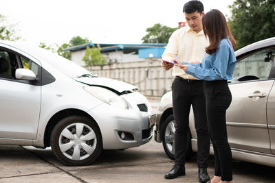 Full length of woman standing on car