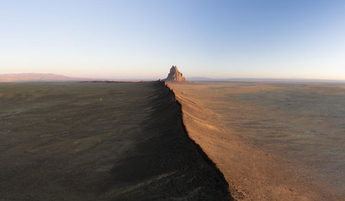Aerial with leading line of lava towards shiprock in new mexico