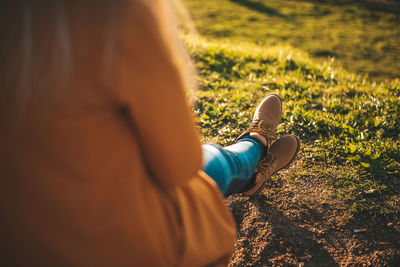 Low section of woman sitting on field