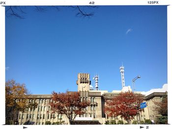 Low angle view of buildings against clear blue sky