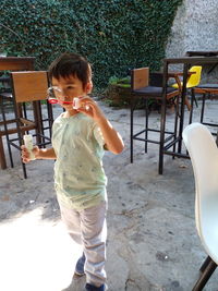 Cute boy standing on seat