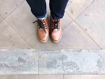 Low section of man standing on footpath