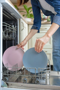 Midsection of man and woman standing on metal