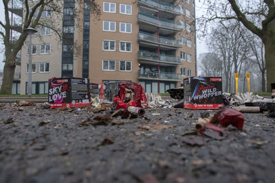 Surface level of empty road amidst buildings in city