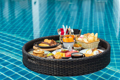 Food on table by swimming pool