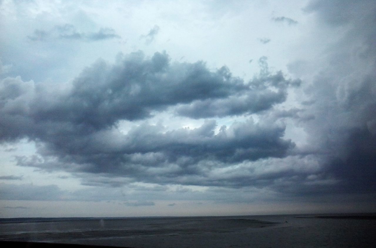 sea, horizon over water, sky, tranquil scene, water, scenics, tranquility, beauty in nature, beach, cloud - sky, cloudy, nature, shore, weather, idyllic, overcast, cloud, remote, seascape, calm