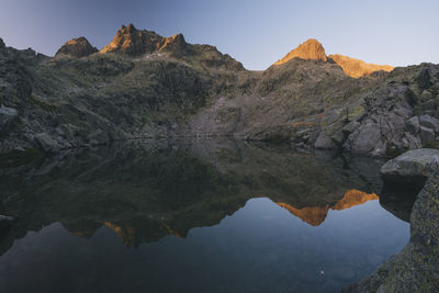 Granite peaks reflections over the lake at sierra de gredos, spain