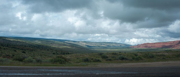 Scenic view of mountains against cloudy sky