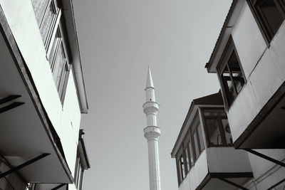 Low angle view of tower amidst buildings against sky