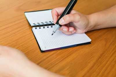 High angle view of person hand on table