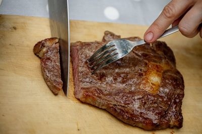 Close-up of person preparing food on cutting board