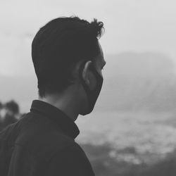 Portrait of young man against sky