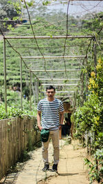 Full length portrait of man standing on walkway