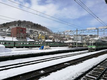 Train at railroad station against sky