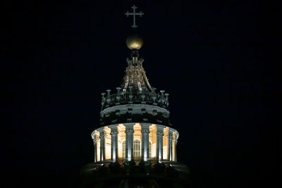 Low angle view of illuminated building against sky at night