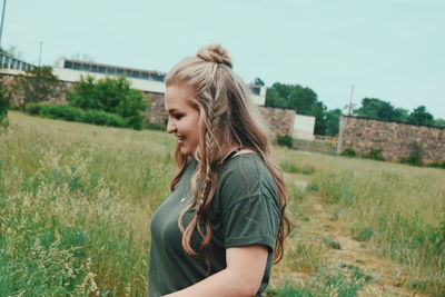 Woman standing on grassy field