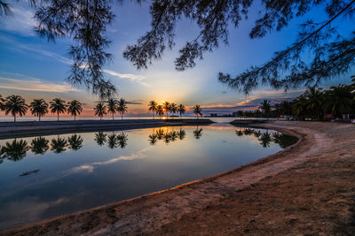 Scenic view of beach against sky during sunset