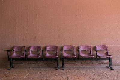 Empty chairs against wall