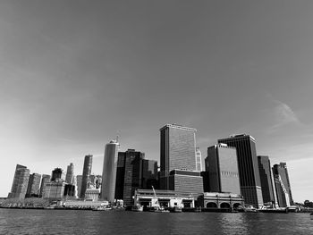 Modern buildings by sea against sky