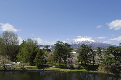 Scenic view of mountains and trees against sky