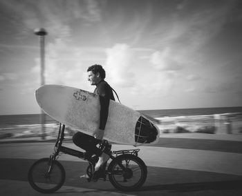 Man riding bicycle on beach