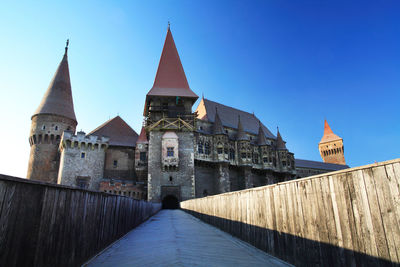 Footpath by corvin castle against blue sky
