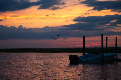 Scenic view of sea against orange sky