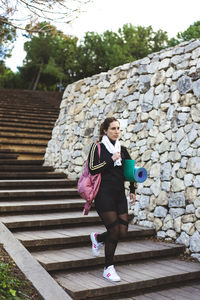 Full length of woman walking on staircase outdoors