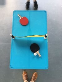 Low section of sports players standing by table tennis