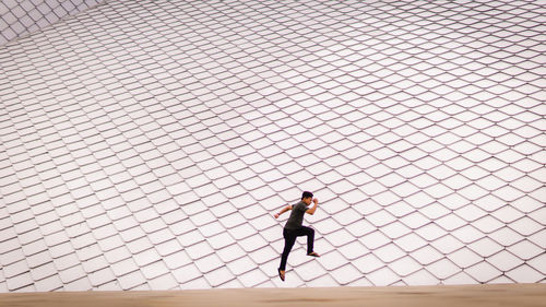 Side view of woman standing on field against sky