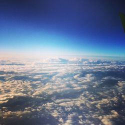 Aerial view of landscape against blue sky