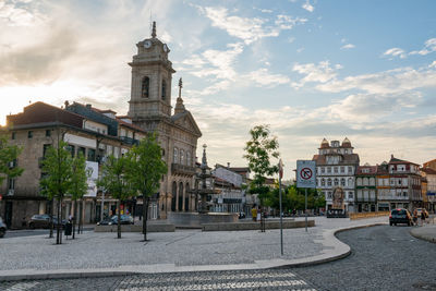 Buildings in city against cloudy sky