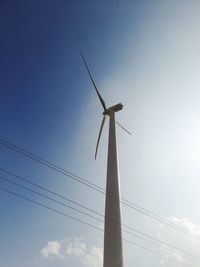 Low angle view of wind turbine against clear sky