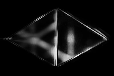 Close-up of glass object over black background