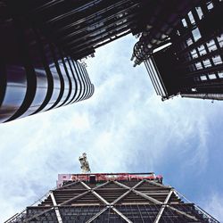 Low angle view of modern building against cloudy sky