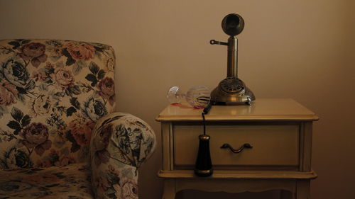 Close-up of spilled wine and phone on table at home