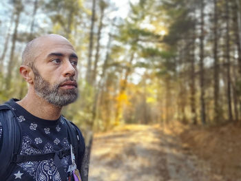 Portrait of man standing in forest