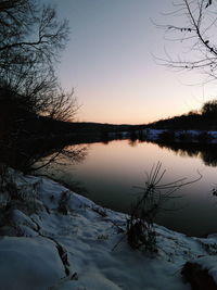 Scenic view of lake against sky during winter