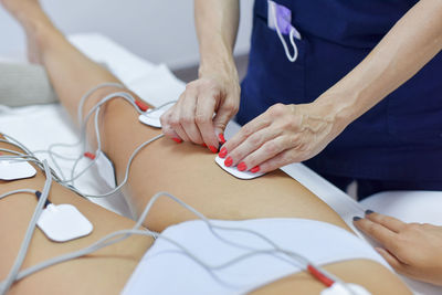 Midsection of woman lying on bed