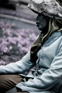 Side view of woman sitting on field